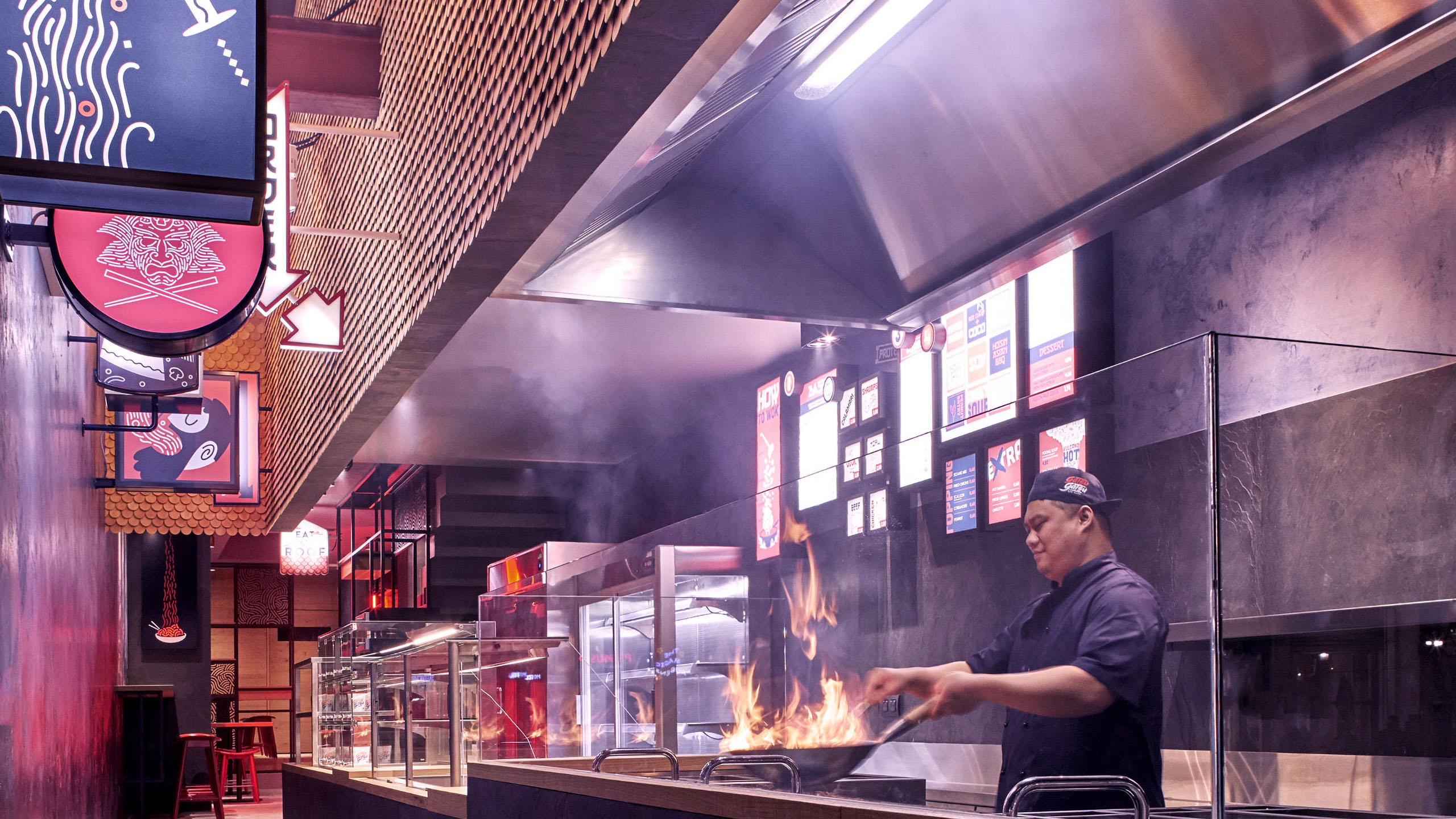 A man cooking in a wok at Gatsu Gatsu.